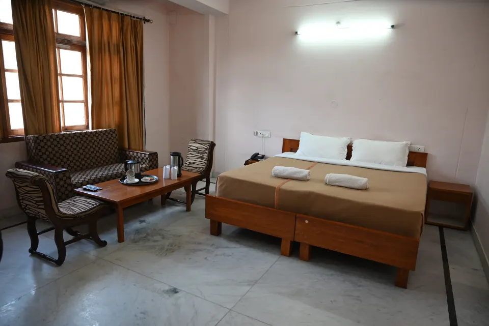 Grand Deluxe Room with large windows and sitting area