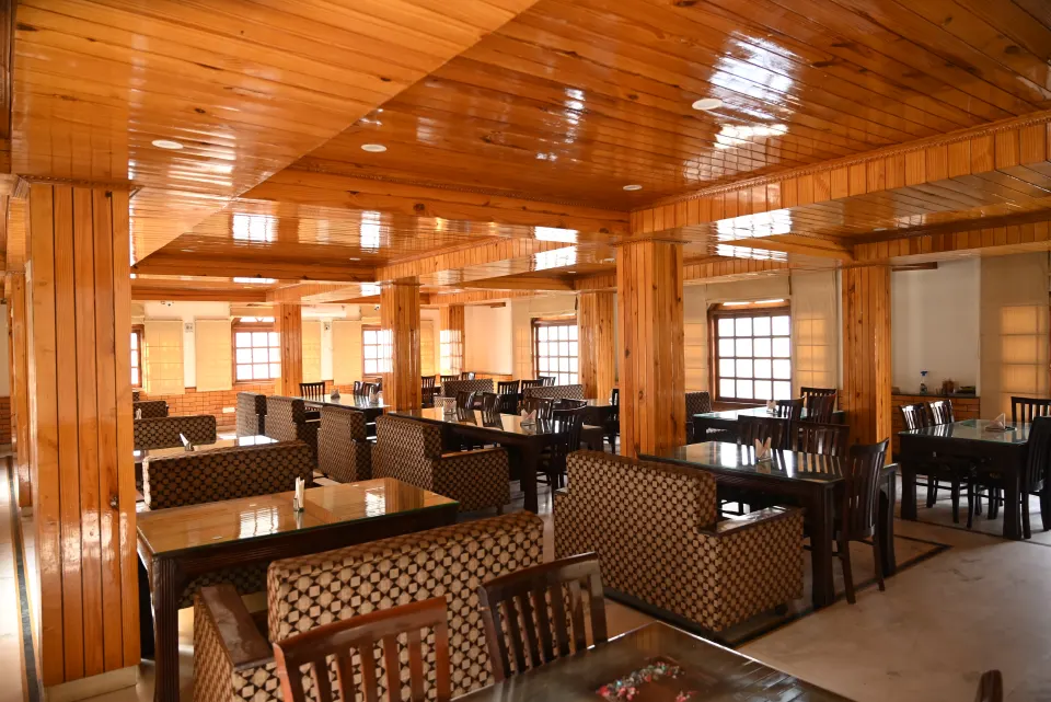Restaurant seating with cushioned sofas and wooden panelling